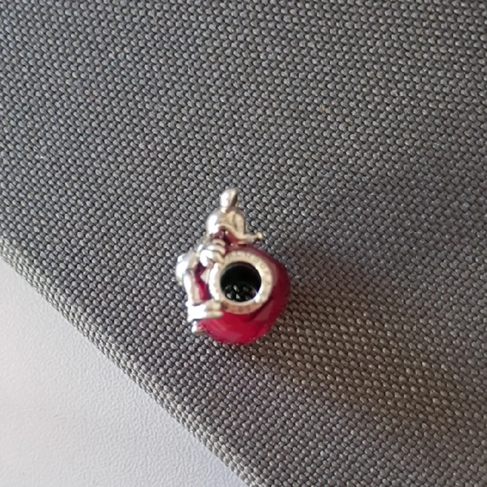 Pandora Disney Mickey Mouse Heart charm featuring a fuchsia crystal.